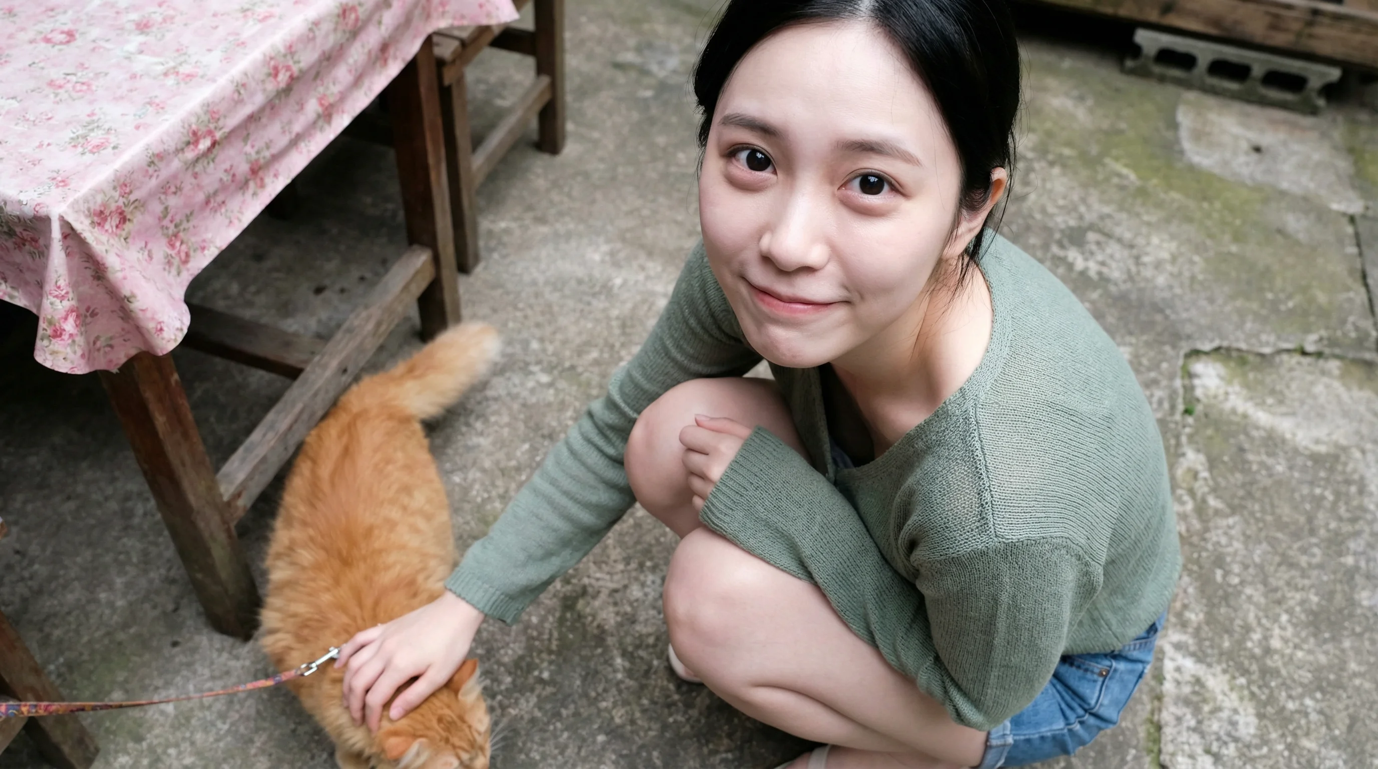 A hyper-realistic candid photo from a high angle showing a young Asian woman squatting on a concrete patio.